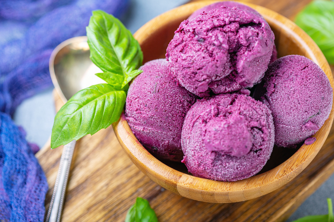 Blueberry ice cream with green basil close-up.